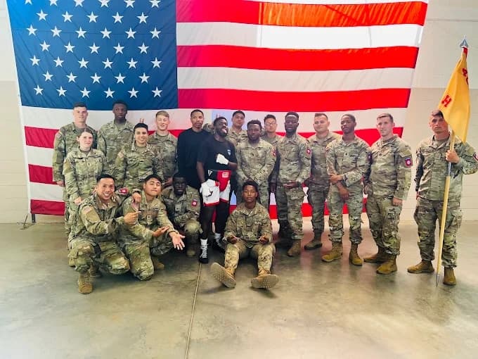 Mad House boxing community with service members in front of the American flag